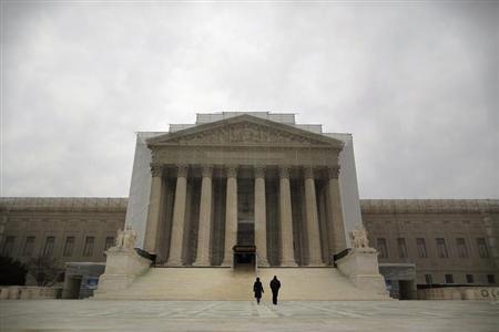 People walk in front of the Supreme Court building in Washington