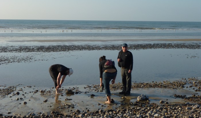 Carla, my father and I taking our shoes off to walk into the surf. Photo by Rosemary Williams