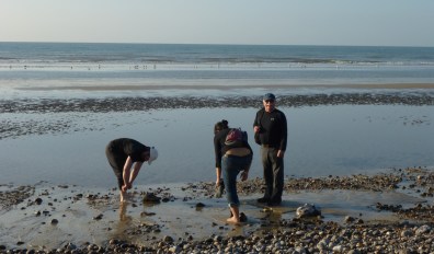 Carla, my father and I taking our shoes off to walk into the surf. Photo by Rosemary Williams
